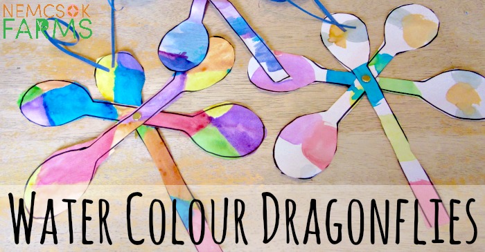 Water colour dragonfly painting with curled paper antennae and brad fasteners